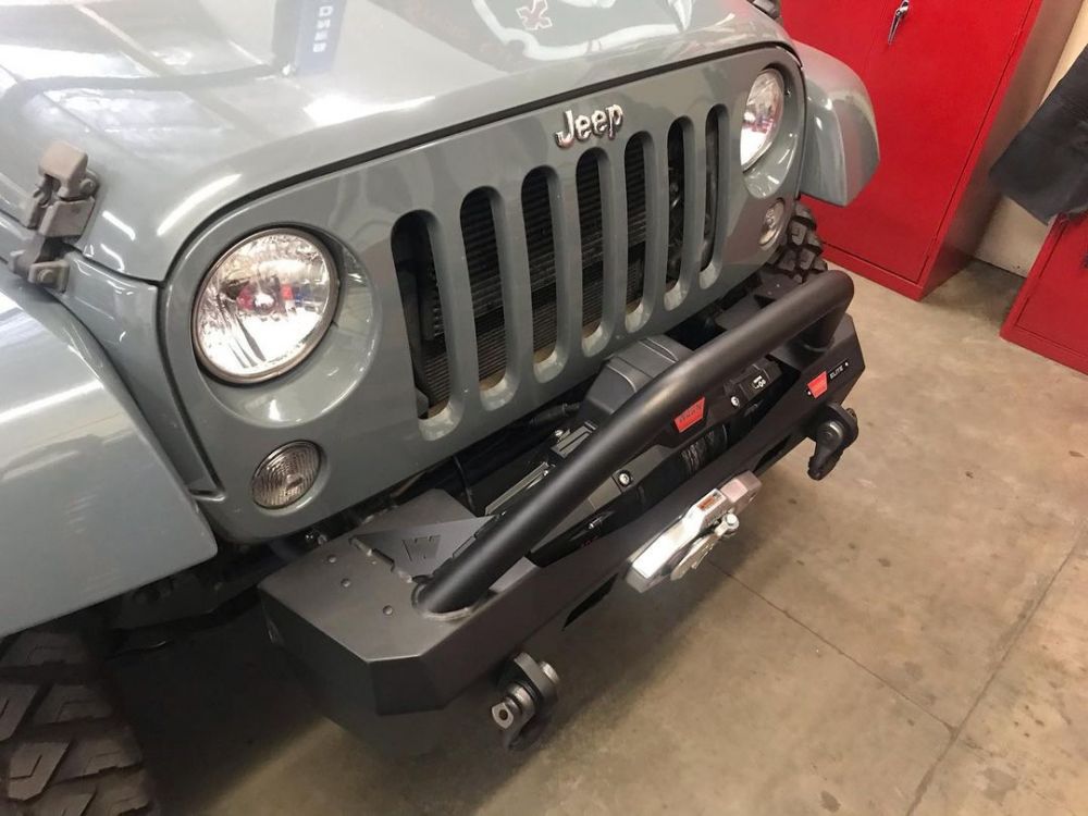 The WARN Elite Stubby front bumper provides a strong place for a winch up to 12,000 lbs, such as this ZEON unit. The narrow design allows for maximum approach angles and articulation. It’s available with or without the grille guard tube, has recovery points for shackles, and is available for both รถ Jeep Wrangler JK or JL or Gladiator JL. 

