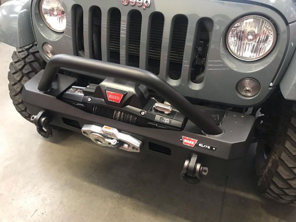 The WARN Elite Stubby front bumper provides a strong place for a winch up to 12,000 lbs, such as this ZEON unit. The narrow design allows for maximum approach angles and articulation. It’s available with or without the grille guard tube, has recovery points for shackles, and is available for both รถ Jeep Wrangler JK or JL or Gladiator JL. 
